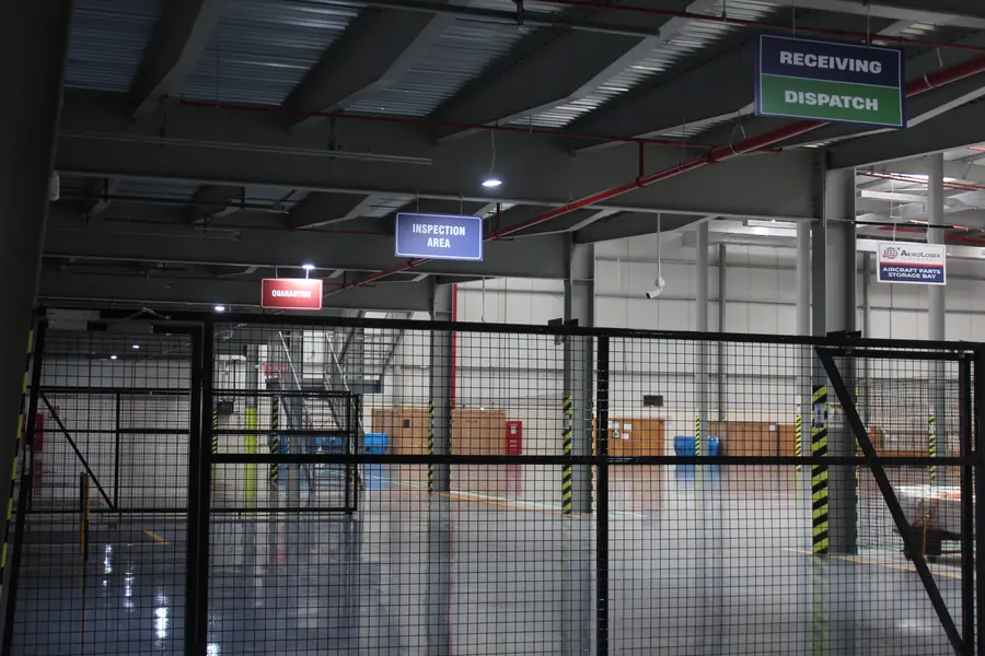 Caged, access-controlled bonded area inside the warehouse