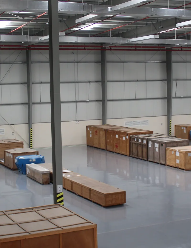 Crated aerospace parts stored on the open warehouse floor at Aerologix Global